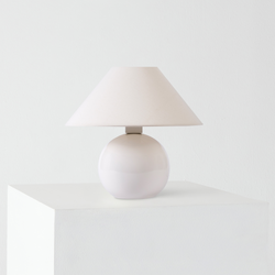 Minimalist white ceramic table lamp with beige fabric shade on white pedestal, modern bedside lamp for home decor