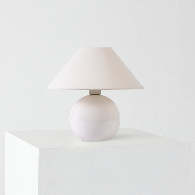 Minimalist white ceramic table lamp with beige fabric shade on white pedestal, modern bedside lamp for home decor