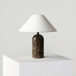 Minimalist modern marble table lamp with white linen shade on a white pedestal — bedside and living room decor