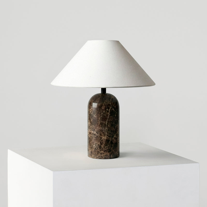 Minimalist modern marble table lamp with white linen shade on a white pedestal — bedside and living room decor