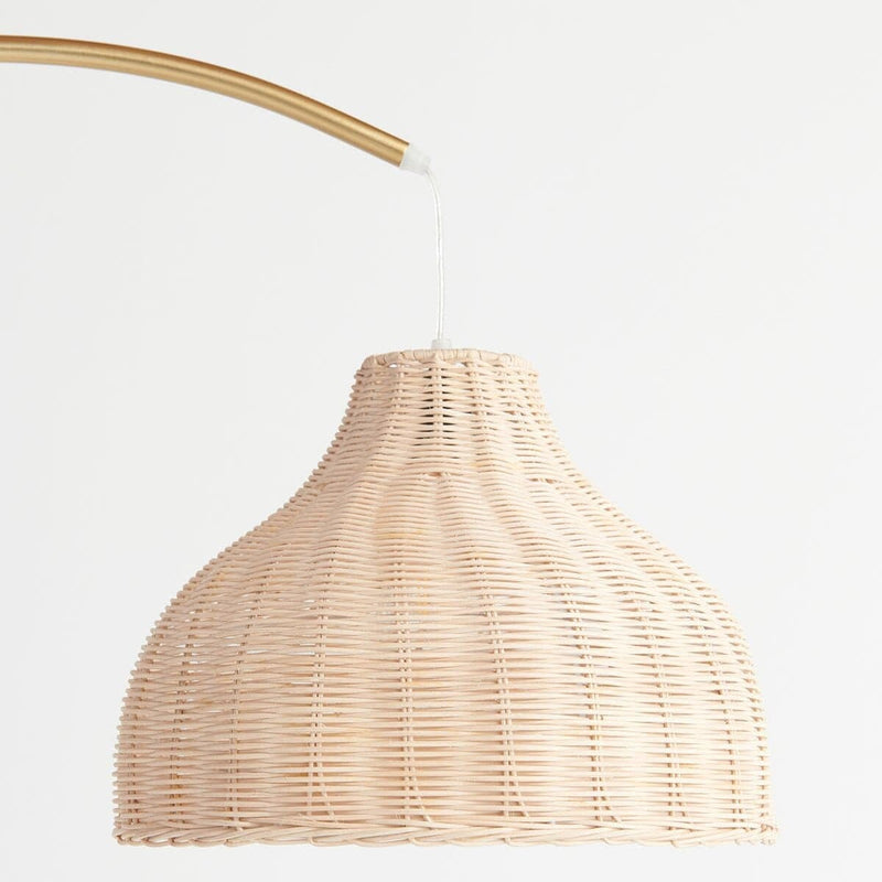 Woven rattan pendant lamp with curved golden arm, minimalist home decor lighting.