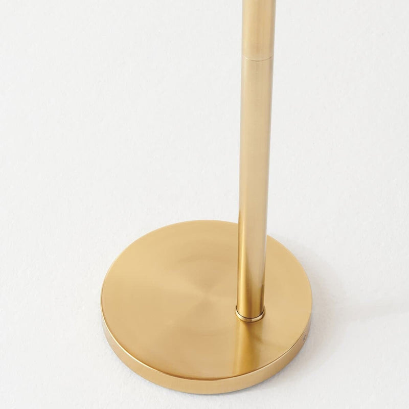 Gold floor lamp base on a white background, minimalist home decor design.