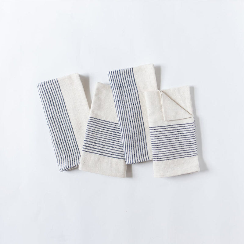 Set of striped cotton kitchen towels on a light background.