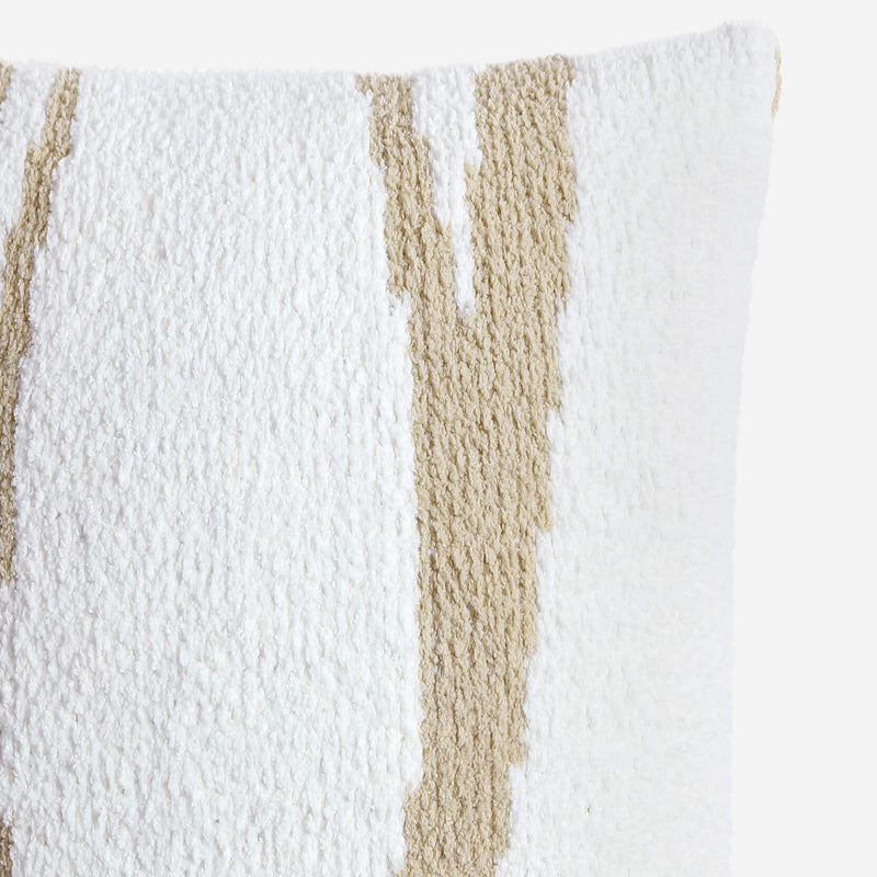 Close-up of a textured cushion with white and beige stripes, ideal for modern home decor.