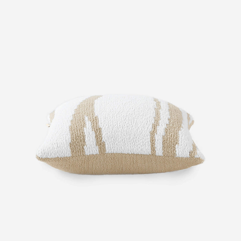 Decorative beige and white patterned cushion for modern home decor.