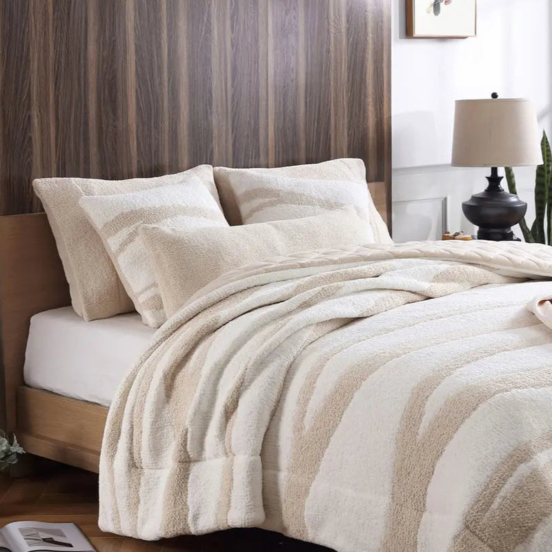 Luxurious beige and white striped bed set in modern bedroom with wooden headboard and decorative lamp.
