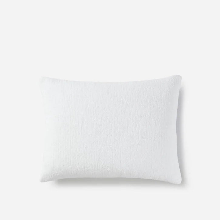 White pillow on a plain background, premium cotton cover for comfortable and restful sleep.