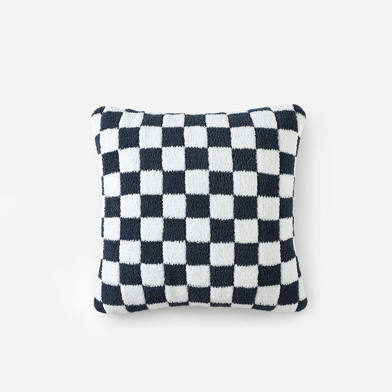 Black and white checkered decorative pillow on white background.