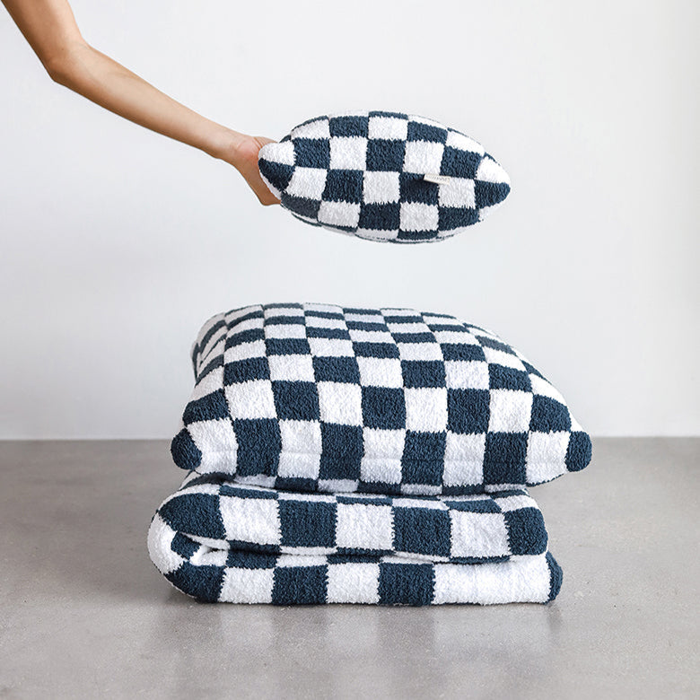 Checkered black and white throw pillows and blanket set, modern home decor.