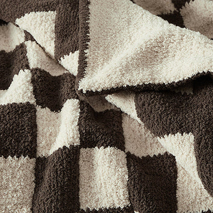 Cozy black and white checkerboard fleece blanket with textured squares.