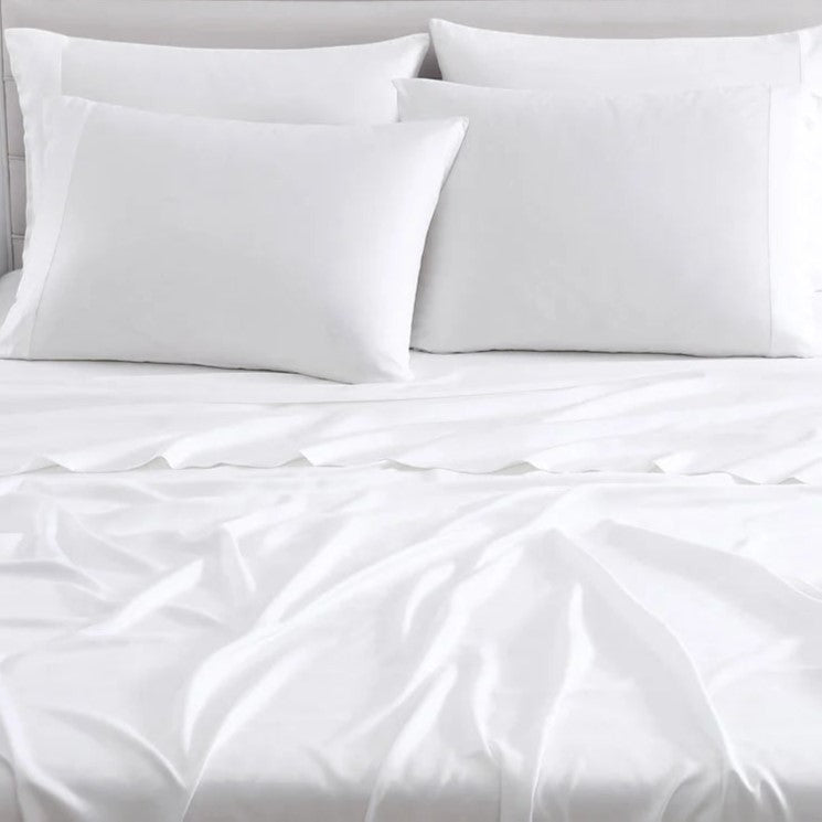 Luxurious white bedding set with soft pillows and sheets for a comfortable night's sleep.