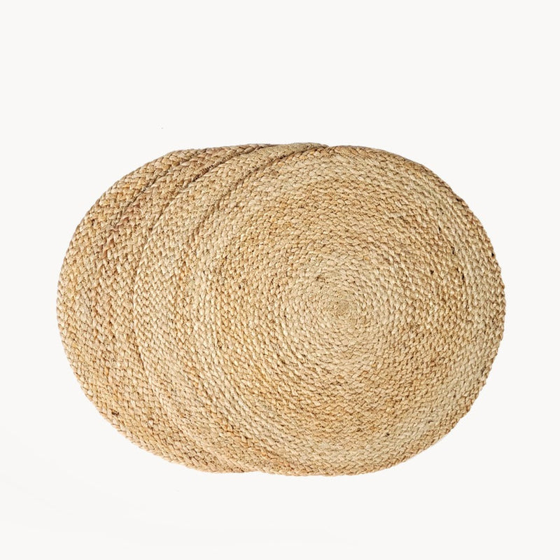 Set of three round woven jute placemats for rustic table decor.