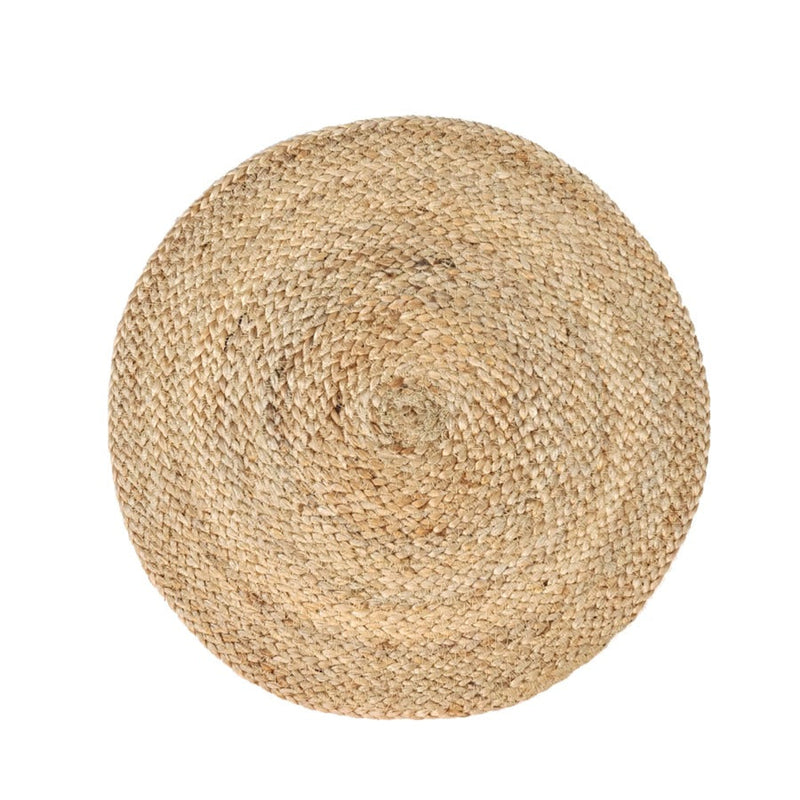 Natural woven round jute rug on white background.