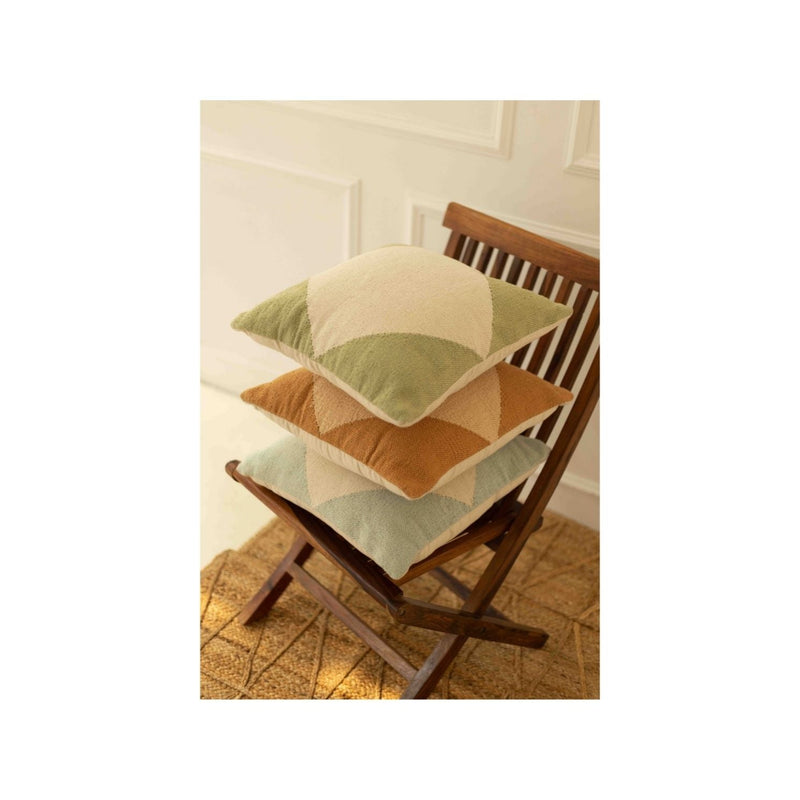 Stack of decorative throw pillows with geometric patterns on wooden chair, enhancing cozy home decor aesthetics.