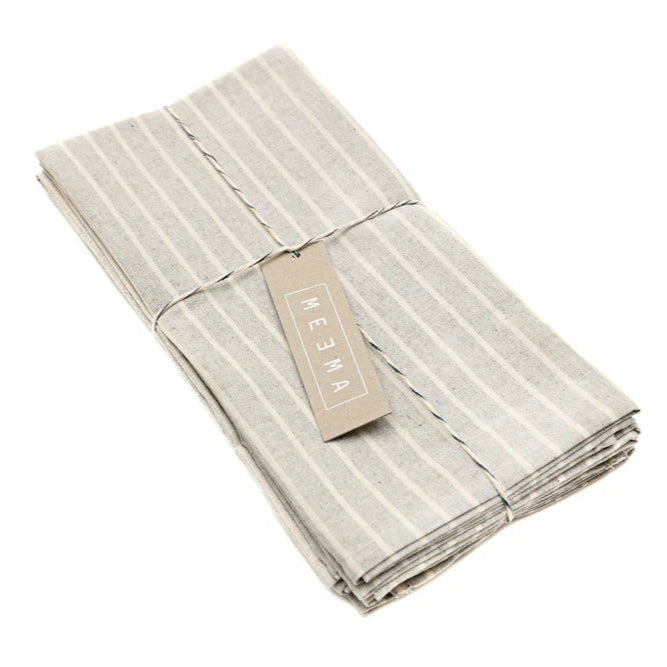 Folded gray striped linen napkin set with packaging tag.