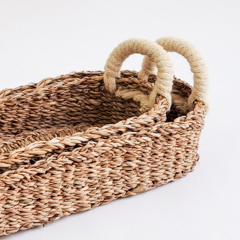 Woven rattan baskets with handles for stylish home organization.