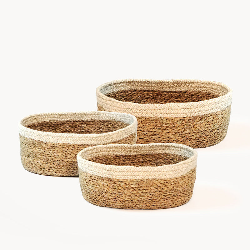 Handwoven oval jute baskets set, natural storage solution for home organization.