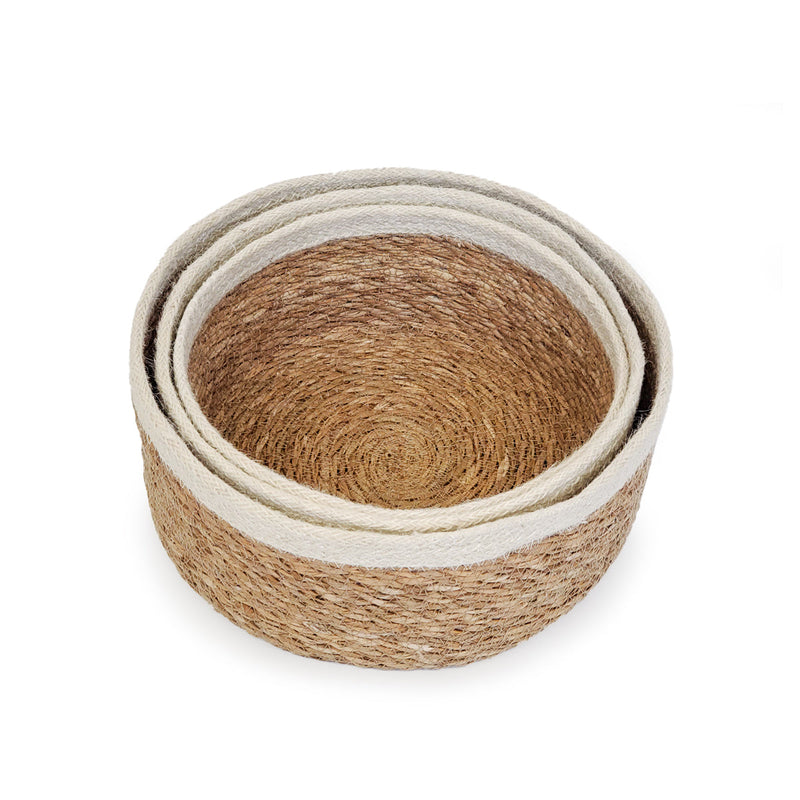 Nested round woven jute baskets with white trim for home storage and decor.