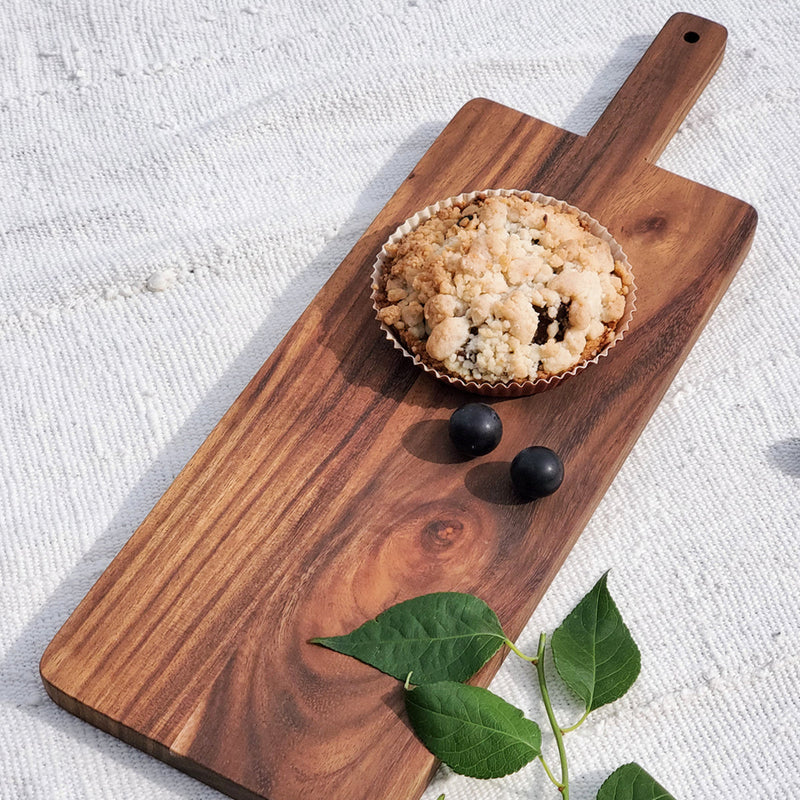 Rustic wooden serving board with a homemade blueberry crumble and fresh grapes, perfect for a cozy brunch aesthetic.