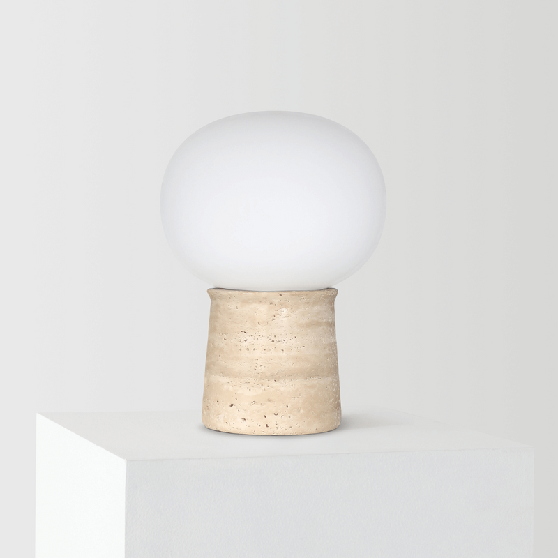 Minimalist round table lamp with a beige stone base and a smooth white globe shade, ideal for modern interior decoration.