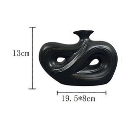 Modern black ceramic vase with abstract design, measuring 13cm x 19.5cm x 8cm, perfect for contemporary home decor.