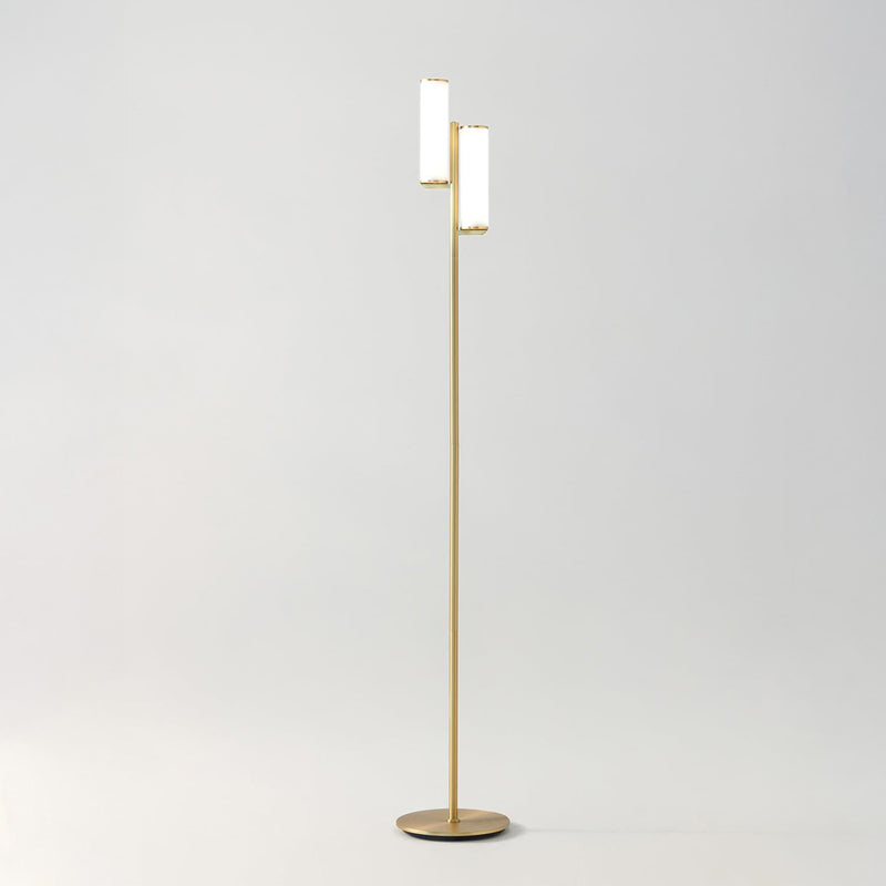 Modern brass gold two-light LED floor lamp with cylindrical white shades on slim stand for minimalist living room lighting