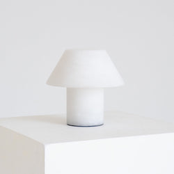 Minimalist white table lamp on a white pedestal, modern Scandinavian ceramic bedside lamp product photo