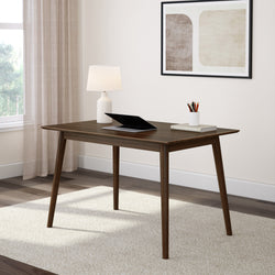 Mid-century modern wooden desk with lamp and laptop in a bright, minimalist home office setting.