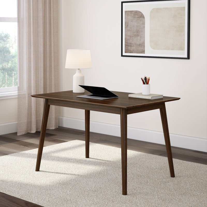 Mid-century modern wooden desk with lamp and laptop in a bright, minimalist home office setting.