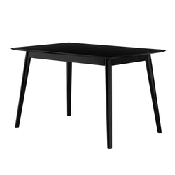 Modern black dining table with sleek design and four legs, suitable for contemporary home interiors.