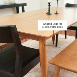 Mid-century modern dining table with angled legs for a sleek, retro look.