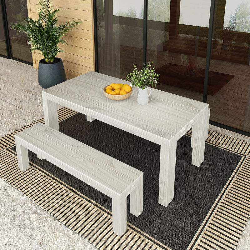 Outdoor wooden dining set with a table and bench on a decorative patio, featuring a potted plant and a bowl of lemons, ideal for al fresco dining.
