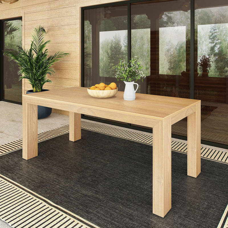 Modern wooden dining table on patio with decorative plants and fruit bowl.