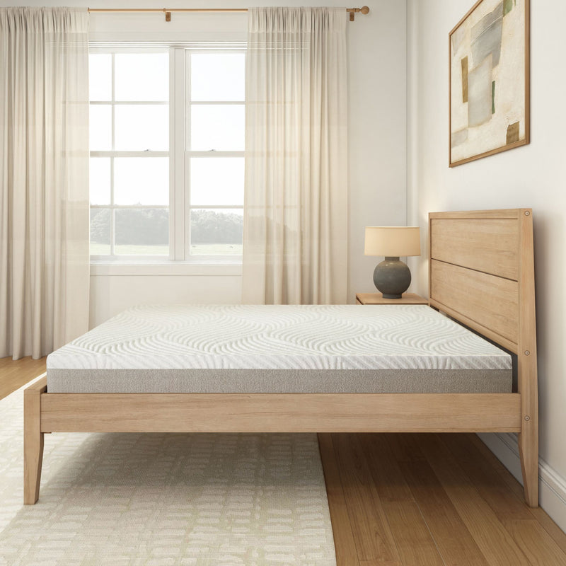 Modern minimalist bedroom with wooden bed frame, comfortable mattress, and soft natural light through curtains.