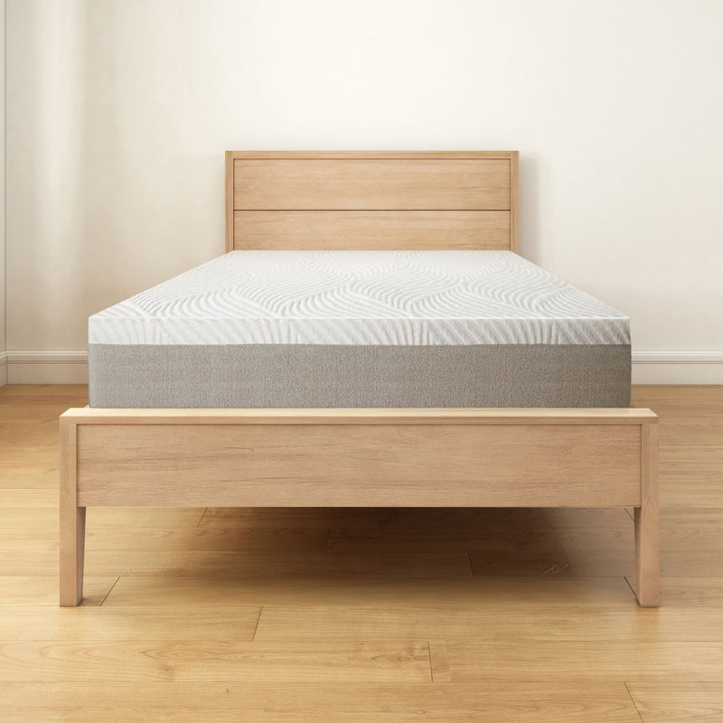Modern wooden bed frame with a comfortable mattress in a minimalist bedroom setting.