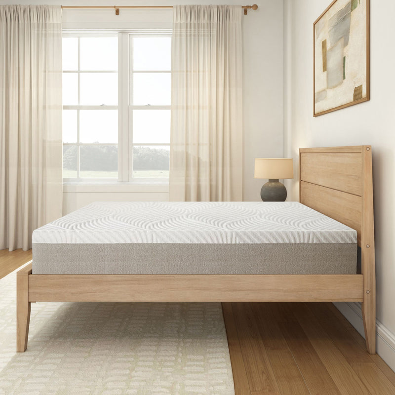 Modern wooden platform bed with a comfortable mattress in a bright, airy bedroom with light curtains and a stylish lamp.