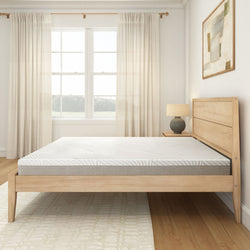 Modern minimalist bedroom with wooden bed frame and comfortable mattress.