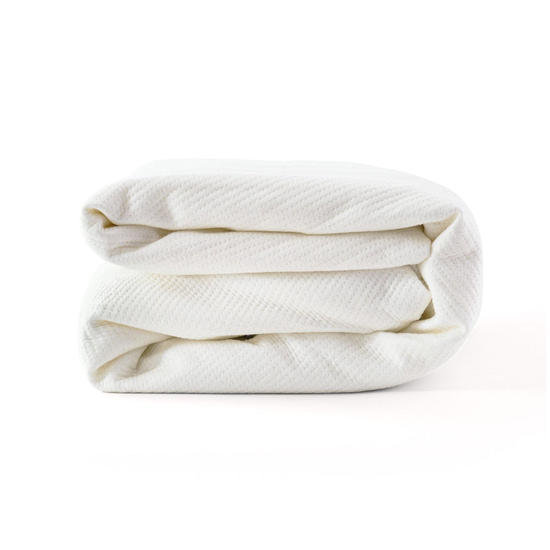 Folded white blanket made from soft, breathable fabric for ultimate comfort.