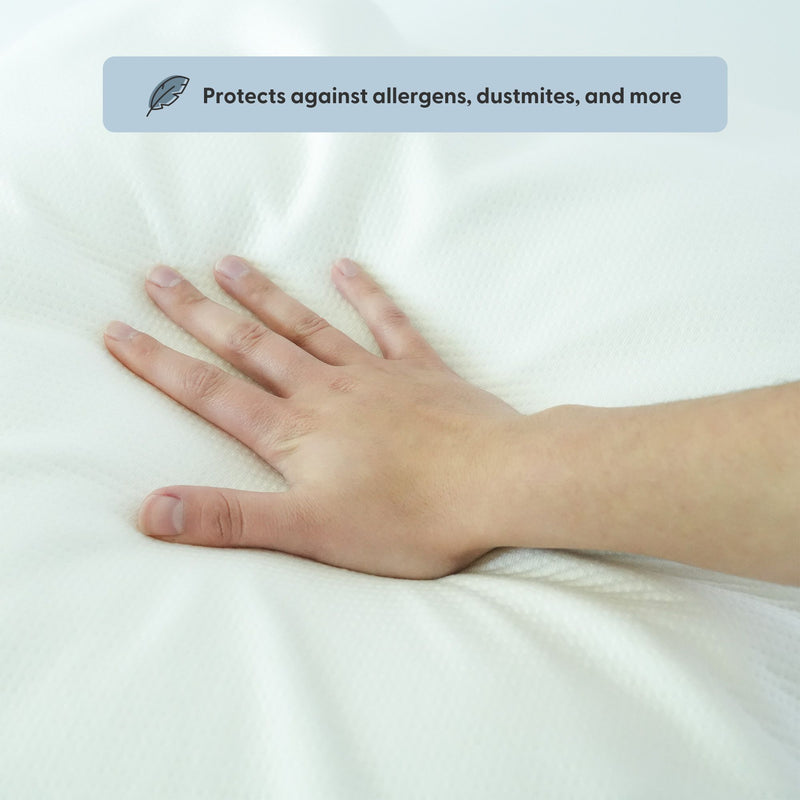 Hand pressing on hypoallergenic mattress protector, shields against allergens and dust mites.