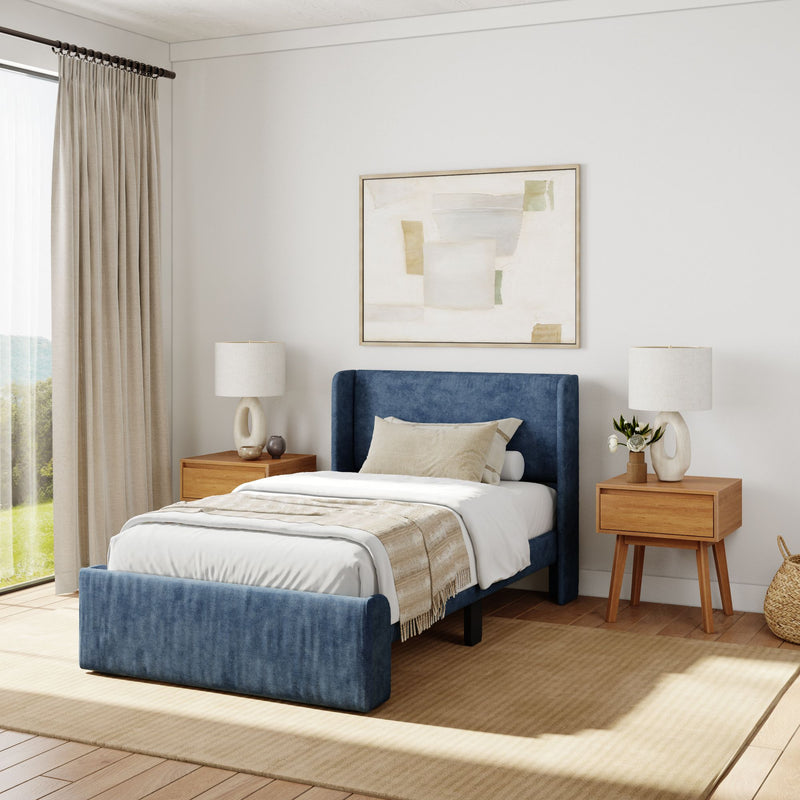 Elegant bedroom with blue upholstered bed, wooden nightstands, and minimalist decor for a modern aesthetic.