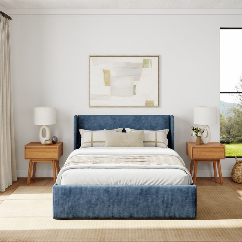 Modern bedroom design with a blue upholstered bed, wooden nightstands, and neutral decor elements.