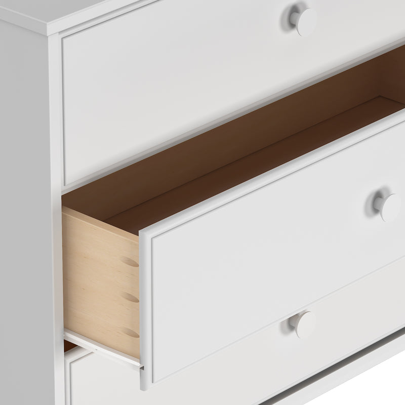 White wooden dresser with an open drawer, modern furniture design close-up.