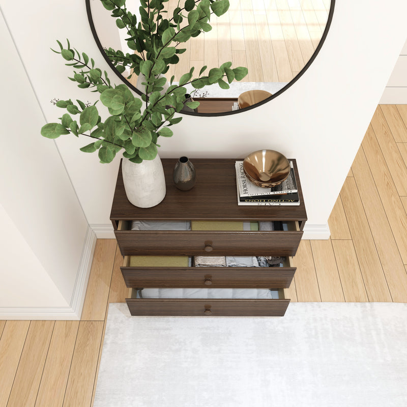 Modern wooden dresser with open drawers, decorative vase, and mirror in a minimalist bedroom.