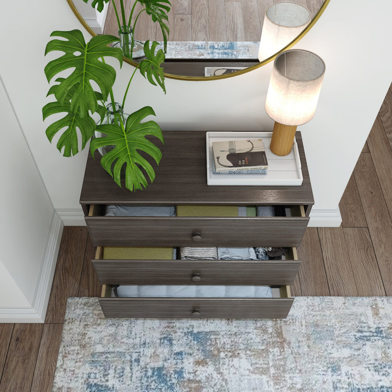 Elegant wooden dresser with open drawers, decorative lamp, and potted plant, perfect for modern interiors.
