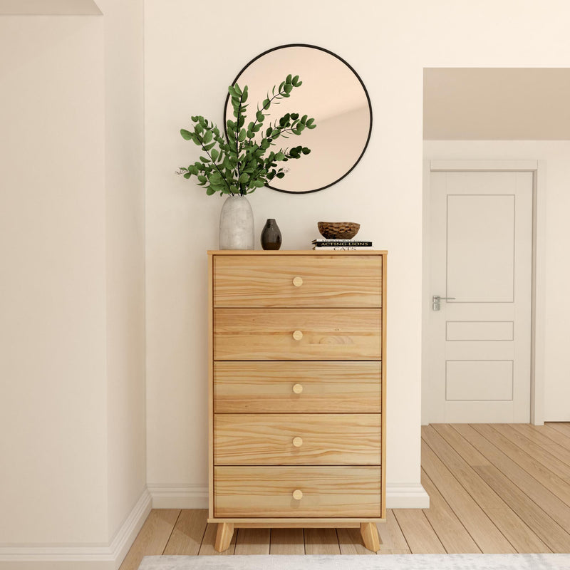 Natural wood dresser with round mirror and decorative vase in a modern minimalist bedroom.