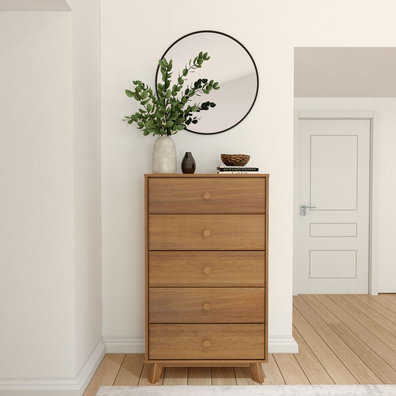 Wooden dresser with circular mirror and decorative plants in a modern, minimalist room setting.