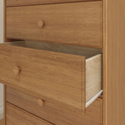Wooden dresser with open drawer, showcasing natural oak finish and sleek design.