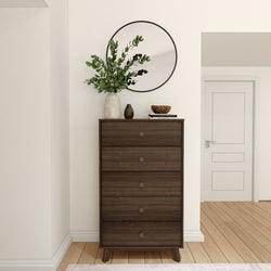 Modern wooden dresser with decorative mirror and vase in minimalist room decor.