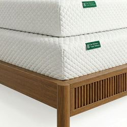 Close-up of two stacked 8-inch gel memory foam mattresses with white quilted covers resting on a wooden slatted bed frame
