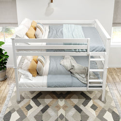 White wooden bunk bed with blue bedding and decorative pillows, located in a bright room with a patterned rug and potted plant.